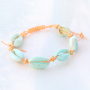 Tropische sieraden met kauri schelpjes
